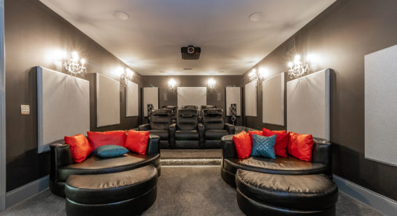 Beautiful Media Room with Tiered Theater Seating and Luxurious Leather Chairs Sound Deadening Acoustic Wall Panels Tower Speakers Projector Ground Mood Lighting Thomas Theater