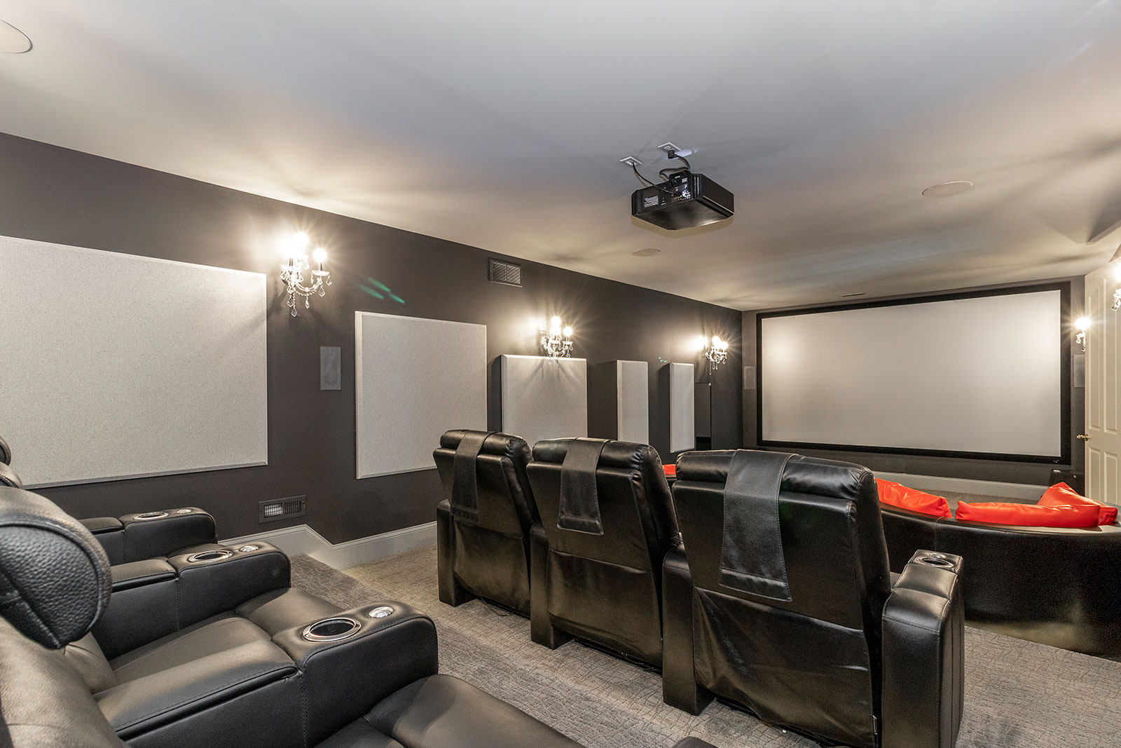 Beautiful Media Room with Tiered Theater Seating and Luxurious Leather Chairs Sound Deadening Acoustic Wall Panels Tower Speakers Projector Ground Mood Lighting Thomas Theater