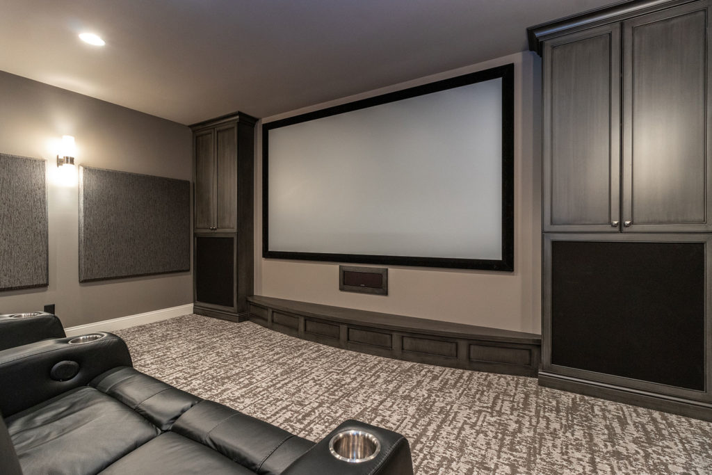 Media Room with Leather Recliner Theater Seating and Kitchenette withall Speakers and Wires Concealed Inside Custom Cabinets