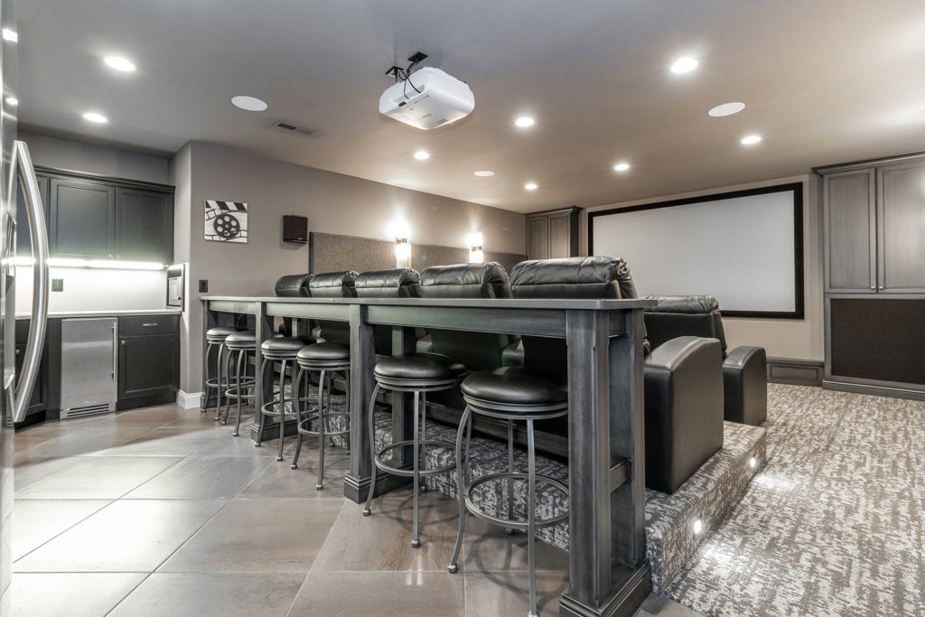 Media Room with Tiered Theater Seating, Leather Chairs and a Full Wet Bar Kitchenette. Sound Deadening Acoustic Panels. Invisible Speakers. Digital Projector. Theater Lighting.