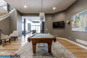 Columbia MO Custom Home with Wall Mounted Television Floating over Billiards Pool Table Game Room Man Cave by Pure Audio